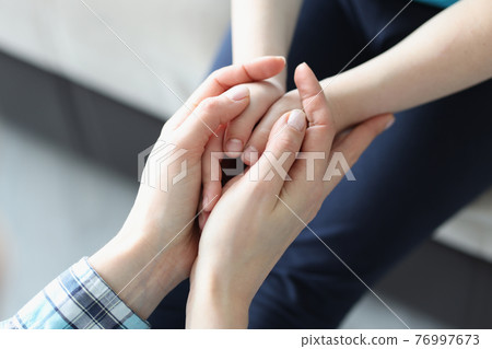 Women and children hands joined together closeup 76997673