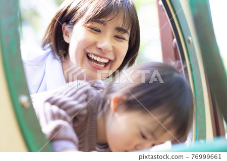 Nursery teacher and 2 year old girl 76999661