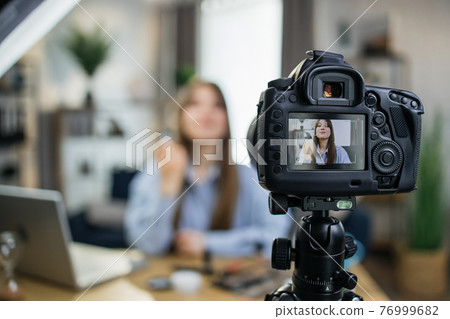 Caucasian woman filming tutorial about cosmetics 76999682
