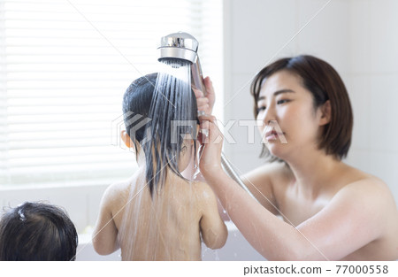 Twin toddlers and mom taking a bath Twin toddlers and mom taking a bath 77000558