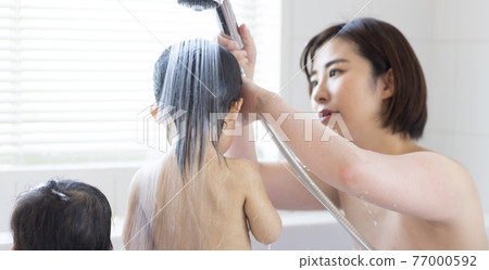 Twin toddlers and mom taking a bath Twin toddlers and mom taking a bath 77000592