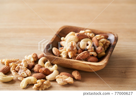 Mixed nuts in a wooden bowl Mixed nuts in a wooden bowl 77000627