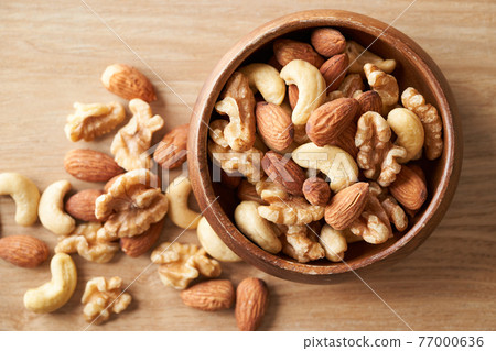 Mixed nuts in a wooden bowl 77000636