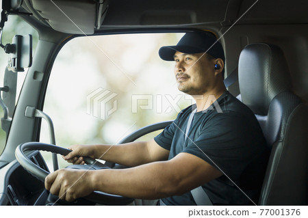 Truck driver is driving a transport vehicle. 77001376