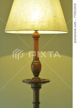 Mahogany antique lamp in a dimly lit room. British furniture (vivid tone, soft focus) Mahogany antique lamp in a dimly lit room. British furniture (vivid tone, soft focus) 77001919