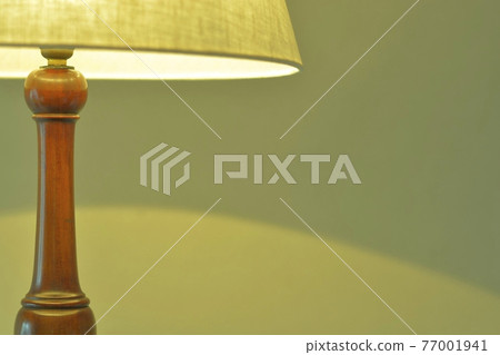 Mahogany antique lamp in a dimly lit room. British furniture (vivid tone, soft focus) Mahogany antique lamp in a dimly lit room. British furniture (vivid tone, soft focus) 77001941