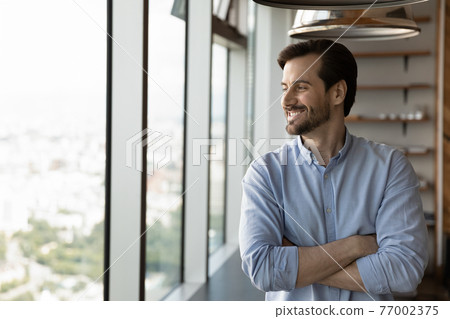 Smiling businessman look in distance making plans 77002375