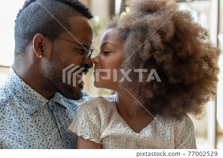 Happy millennial dad spending time with cute little daughter Happy millennial dad spending time with cute little daughter 77002529