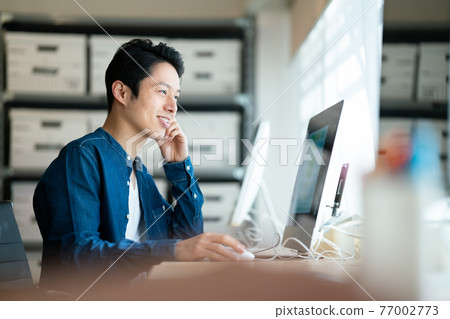 A man doing a design job A man doing a design job 77002773