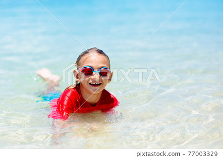 Kids playing on beach. Children play at sea. Kids playing on beach. Children play at sea. 77003329