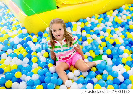 Kids play in ball pit. Child playing in balls pool Kids play in ball pit. Child playing in balls pool 77003330