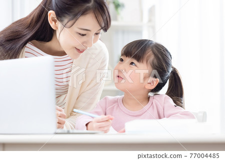 Family image Girl doing homework with mom Family image Girl doing homework with mom 77004485