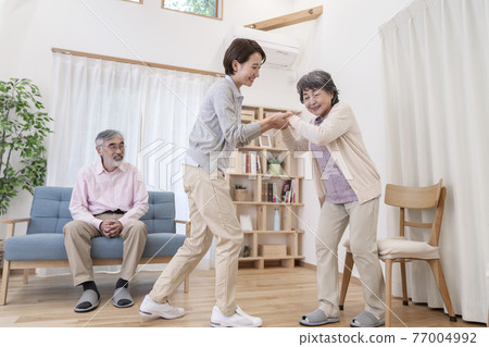 Caregiver caregiving image to assist walking Caregiver caregiving image to assist walking 77004992