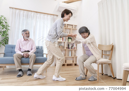 Caregiver caregiving image to assist walking Caregiver caregiving image to assist walking 77004994
