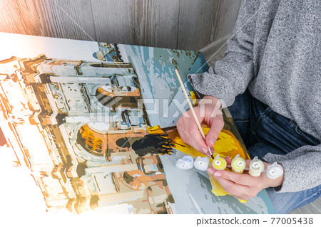 Female hands coloring canvas Picture by numbers girl Triumphal Arch Paris. Creative hobby. Painting for beginners. Leisure activity for stay home isolation, anti-stress idea. Meditation, relax concept Female hands coloring canvas Picture by numbers girl Triumphal Arch Paris. Creative hobby. Painting for beginners. Leisure activity for stay home isolation, anti-stress idea. Meditation, relax concept 77005438