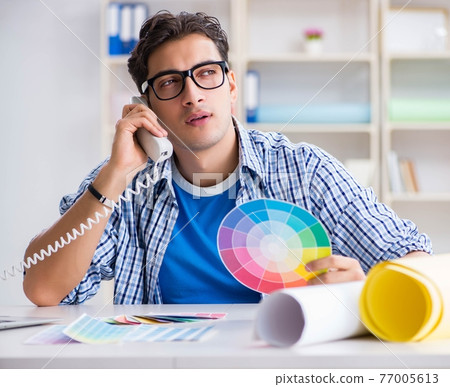 Young designer working on new project and choosing colours 77005613