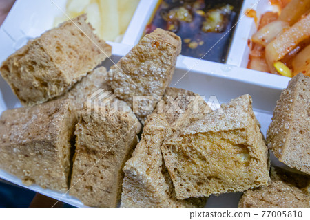 Stinky tofu, a close up of Taiwanese traditional deep fried beancurd street food at Taipei night market in Taiwan. 77005810