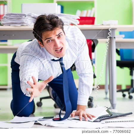 Frustrated businessman stressed from excessive work 77006082