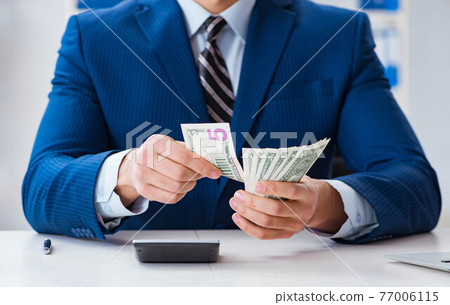 Accountant calculating dollars with calculator in office Accountant calculating dollars with calculator in office 77006115