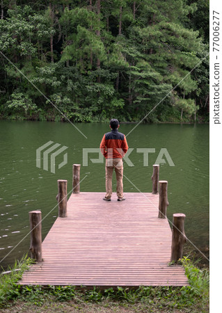 Happy traveler man standing and looking Nature view, solo tourist in sweater traveling at Pang Oung, Mae Hong Son, Thailand. travel, trip and vacation concept Happy traveler man standing and looking Nature view, solo tourist in sweater traveling at Pang Oung, Mae Hong Son, Thailand. travel, trip and vacation concept 77006277