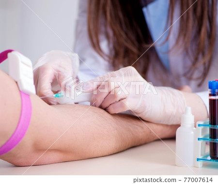 Patient during blood test sampling procedure taken for analysis 77007614