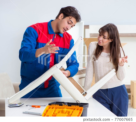 Contractor repairman assembling furniture under woman supervisio 77007665