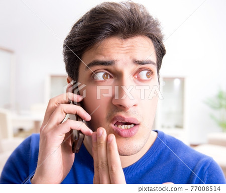 Man panicking because of pimples on the skin 77008514