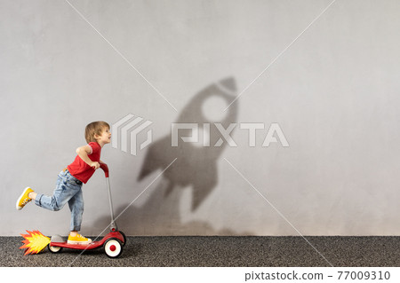 Happy kid dreams about space. Imagination, freedom and motivation concept 77009310