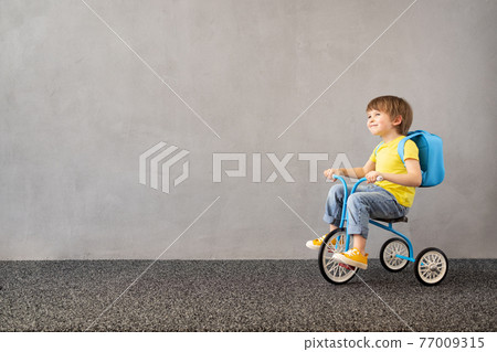 Happy child riding vintage trike 77009315