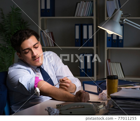 Employee relieving stress from overtime with drugs narcotics Employee relieving stress from overtime with drugs narcotics 77011255