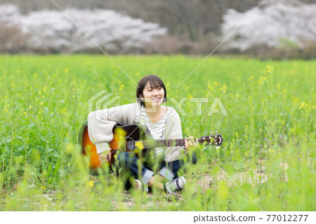 Musician carrying a guitar Musician carrying a guitar 77012277