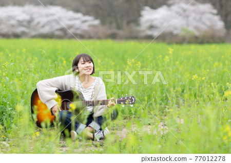 Musician carrying a guitar Musician carrying a guitar 77012278