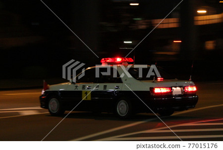 Security patrol car in motion (nighttime, panning shot) Security patrol car in motion (nighttime, panning shot) 77015176
