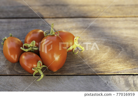 Fresh red tomatoes on vintage wooden table, selective focus 77016959