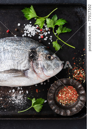 Fresh dorado fish with spices and herbs for cooking 77017302