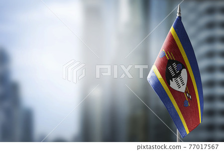 A small flag of Swaziland on the background of a blurred background A small flag of Swaziland on the background of a blurred background 77017567