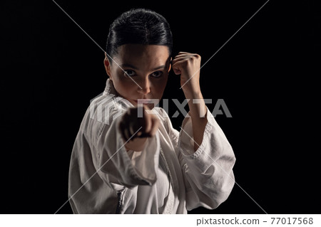 Woman in kimono in fighting stance Woman in kimono in fighting stance 77017568