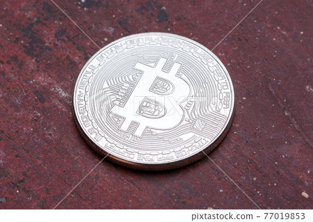 Red background with silver bitcoin on it. Red background with silver bitcoin on it. 77019853