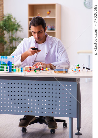 Young male chemist working in the lab Young male chemist working in the lab 77020665