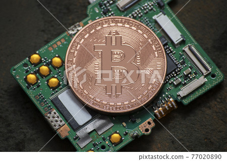 Bitcoin logo coin on computer parts Bitcoin logo coin on computer parts 77020890