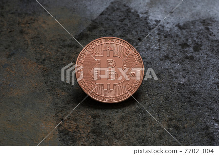Bitcoin logo coin on rusty metal background 77021004