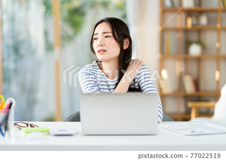 Young woman tired from telework Young woman tired from telework 77022519