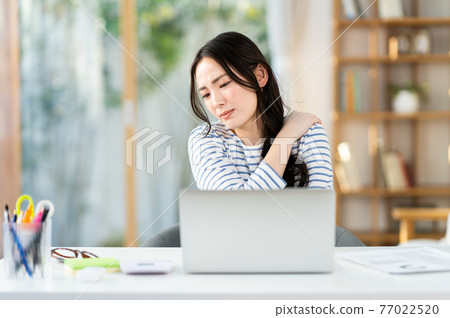 Young woman tired from telework Young woman tired from telework 77022520