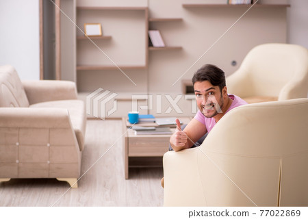 Young man siiting at home during pandemic Young man siiting at home during pandemic 77022869