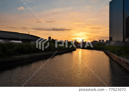 Sunset and twilight scenery reflected on the river surface Sunset and twilight scenery reflected on the river surface 77023072