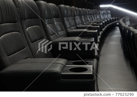 Empty Black Leather Seats In Row At Movie Theater 77023290
