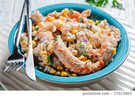 Shrimp salad with corn on a blue plate, close-up Shrimp salad with corn on a blue plate, close-up 77023665