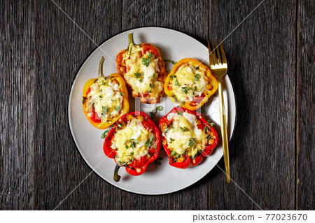 chickpea stuffed peppers on a plate, top view chickpea stuffed peppers on a plate, top view 77023670