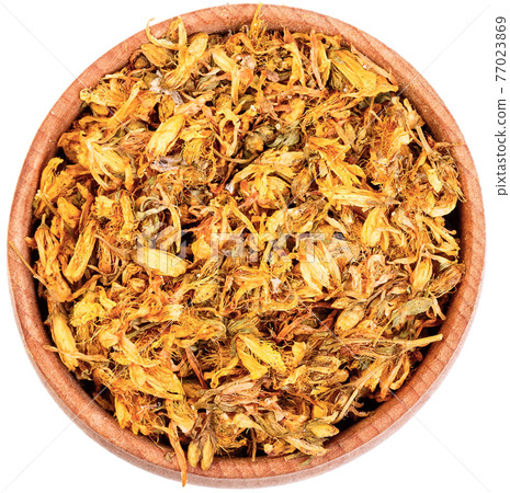 Dry Saint John's Wort, Goat weed, Hypericum, Millepertuis in a small wooden bow close up, isolated on white. 77023869