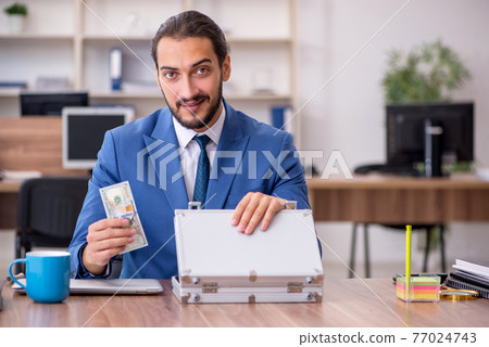 Young male employee in remuneration concept Young male employee in remuneration concept 77024743
